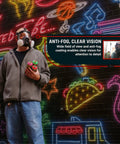 Man wearing Smoke Black Full Face Respirator With Dual Activated Charcoal Filtration For Organic Vapor And Particulate Protection Anti Fog Eye Shield Heavy Duty Mask Built For Rugged Outdoor Gigs And Industrial Settings near neon wall.