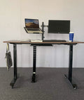 Standing desk on carpet with laptop, monitor, and 2 Inch M8 Threaded PU Swivel Casters Set Of 4 With Brakes For Standing Desks.