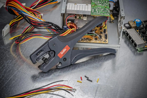 Pro Grade Self Adjusting Wire Stripper with Spring for 32 to 10 AWG, shown with cables and circuit components
