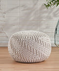 Indoor Outdoor Fabric Weave Pouf In Ivory Cozy Round Handmade Accent Stool For Living Room Or Patio Modern Design Soft Texture Durable Craft Perfect For Extra Seating Footrest And Chill Vibes. 20 inch round ivory pouf on wooden floor with textured pattern.
