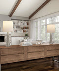 Set Of 2 30 Inch Table Lamps With Hammered Glass Bases, Modern Silver Finish, in stylish living room near large windows.