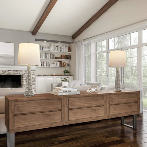 Set Of 2 30 Inch Table Lamps With Hammered Glass Bases, Modern Silver Finish, in stylish living room near large windows.