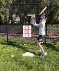 Kid practicing with Full Height Baseball Pitching Net With Wheels For Portable Bullpen Training, suitable for backyard drills.