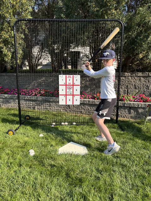 Kid practicing with Full Height Baseball Pitching Net With Wheels For Portable Bullpen Training, suitable for backyard drills.