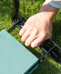 Person folding a Sturdy Steel Garden Kneeler Seat Bench With 330Lb Weight Limit, Fold Flat To Store, EVA Foam Cushioned Pad