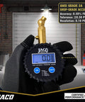 Front view of black JACO digital tire pressure gauge with blue LCD display, held by gloved hand
