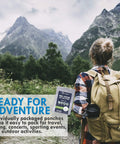 Person hiking with backpack, holding Family Pack Rain Ponchos For All Ages, 20 Clear Hooded Ponchos With Drawstrings, Lightweight Reusable Or Disposable Emergency Rain Gear For Kids And Adults