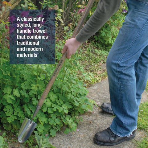 Person using a Stainless Steel Long-Handled Trowel With An Ergonomic Grip For Effortless Digging in the garden, showing back-friendly use.