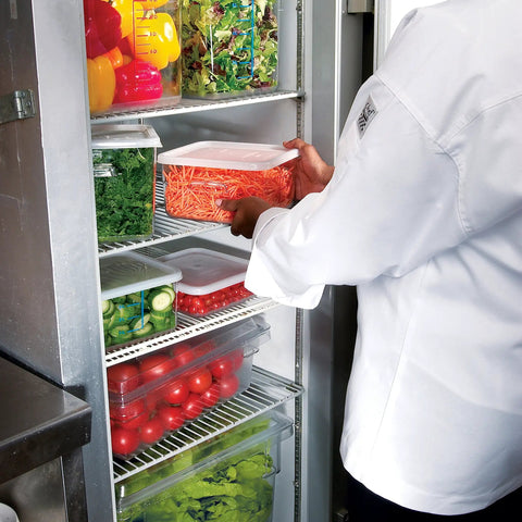 Chef placing Clear Polycarbonate Food Storage Tote 16.5 Gallon in refrigerator, BPA Free, for restaurant kitchen use.