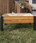 Front view of Teak Wood Raised Garden Bed Planter Box With Galvanized Steel Legs And Mesh Liner for outdoor use on patio.