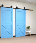 Black Rustic Non-Bypass Sliding Barn Door Hardware Kit For Two Doors With 16Ft Long Flat Track installed in a room.