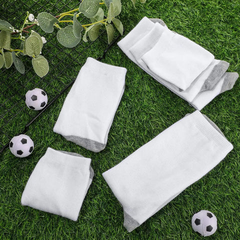 Fifteen Pairs White Sublimation Socks Blanks Made From Polyester For Easy Heat Transfer Crafting Includes Two Metal Sock Jig Inserts In Three Sizes With Gray Sole For DIY Custom Socks displayed on grass.