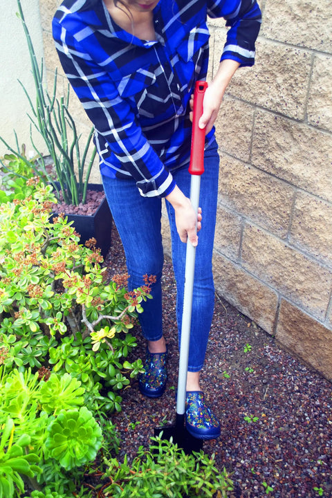 Person using DigMaster Nursery Shovel With ComfortGEL Grip Heavy Duty Steel Blade For Planting Transplanting And Landscaping.