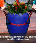 PotLifter plant mover in use lifting a blue ceramic planter with red flowers; two people hold lifting straps.