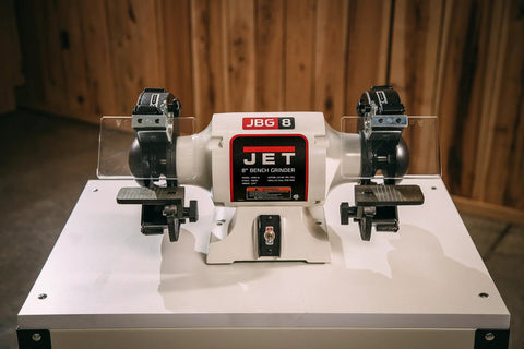 Grit And Grind Eight Inch Bench Grinder With Beefy Half Hp Motor Runs Steady At 1725 Rpm features adjustable tool rests and metal grinding capability.