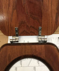 Solid Oak Elongated Toilet Seat with Cover and Polished Chrome Hinges for Vintage Bathrooms close-up of chrome hinges and mahogany finish