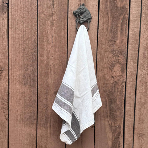 Handcrafted Cast Iron Horsehead Wall Hook With A Knockout Rustic Coffee Bean Brown Finish built like a tank holding a towel.