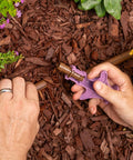 Hands using Drip Irrigation Barbed Fitting Insertion Tool for One Half Inch Tubing in garden setting