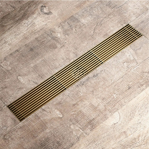 Heavy Duty Rectangular Shower Floor Drain In Sleek Brushed Gold Finish Made From Tough Stainless Steel With Removable Hair Catcher Grate.