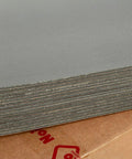 Top Shelf Car Sound Deadener 150 Mil Thick Self Adhesive Closed Cell PE Foam stacked on a cardboard base.