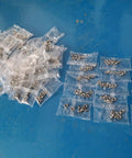 High Speed Auto Screw Packing And Counting Machine For Screw Kits, Pro Packaging System with filled sachets on blue surface