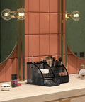 Durable Mesh Desk Organizer With Drawer Six Compartment Pen Holder And Stationery Organizer in black on a vanity with makeup items
