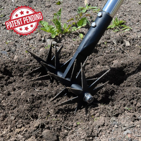 66 Inch Rotary Cultivator With Tempered Spring Steel Tines And Adjustable Stainless Steel Handle in soil.