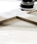 Multi-Jetstream Dust-Free Random Orbital Finish Sander operating on a wooden surface for smooth finishes.