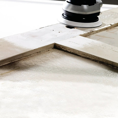 Multi-Jetstream Dust-Free Random Orbital Finish Sander operating on a wooden surface for smooth finishes.