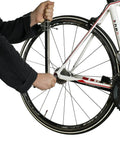 Person using Rear Derailleur Hanger Alignment Gauge For Precise Drivetrain Tuning And Noise Reduction on a bike wheel