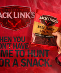 Original Beef Jerky Half Pounder Made With 100 Percent Real Beef Ready To Eat Protein Snack With 10g Per Serving In An 8 Oz Large Bag For Lunches And Outdoor Adventures, Jack Link's bag held in hand
