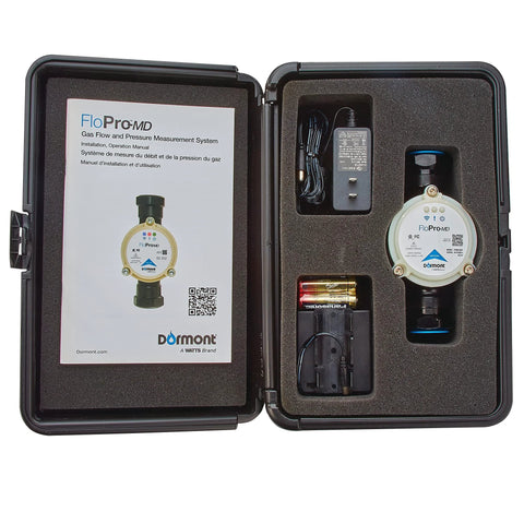 Dormont Flo-Pro MD gas flow and pressure diagnostic tool in a foam-lined hard case with circular sensor, 4‑AA battery pack, and 120V adapter.