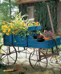 Amish Wagon Garden Planter On Wheels for Indoor Outdoor Decor Blue with flowers, rustic wooden cart on metal wheels in garden setting