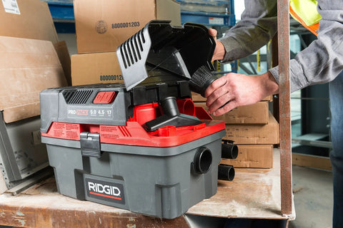 ProPack 4.5 Gallon Portable Wet Dry Shop Vacuum with toolbox design being accessed for flexible hose attachment.