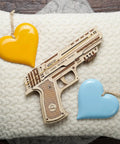 Wolf 01 Handgun 3D Wooden Puzzle Kit For Adults With Mechanical Moving Parts And Realistic Wood Model Gun Brain Teaser And Hobby Set Quick 60 To 90 Minute Assembly No Glue Needed Great Gift For DIYers wooden model pistol on knit fabric with heart ornaments