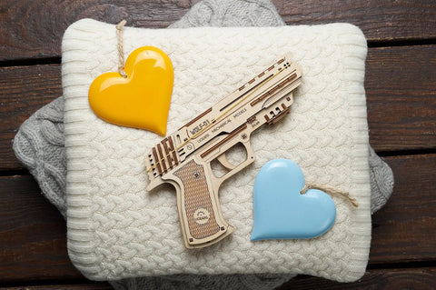 Wolf 01 Handgun 3D Wooden Puzzle Kit For Adults With Mechanical Moving Parts And Realistic Wood Model Gun Brain Teaser And Hobby Set Quick 60 To 90 Minute Assembly No Glue Needed Great Gift For DIYers wooden model pistol on knit fabric with heart ornaments