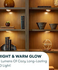 Lit bookshelves with Six Pack Stick On Puck Lights With Remote Controlled DIY LED Under Cabinet Lighting for cozy ambiance.
