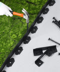 No Dig 148Ft 2 Inch Tall Landscape Edging Kit With 70 Spikes And 20 Connectors being installed on green turf