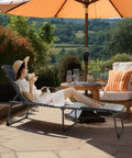 Woman relaxing on Outdoor Patio Chaise Lounge Chair With Face Hole For Beachside Chill And Poolside Kickback, grey color
