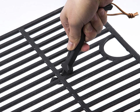 Hand using Cast Iron Grill Grid Lifter, 8 Inch Long Universal Barbecue Grate Lifter for Charcoal and Gas Grills, heavy duty tool.