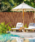 Reed Fencing Rolls 6 Ft By 16.4 Ft Natural Reed Screen Curtain For Outdoor Privacy And Shade in patio by the poolside.