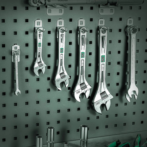 Set of adjustable wrenches hanging on a pegboard, including 10 Inch Adjustable Wrench With 1-7/16 Inch Jaw Opening Chrome Vanadium Steel Rust Resistant.