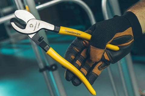 Tough Nine Inch Cable Cutter With Comfort Dipped Grips And Solid Forged Steel Arms used for fast wire snipping in a gloved hand.