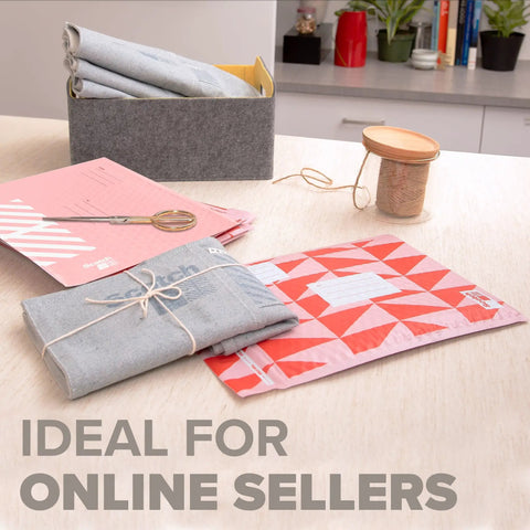 Red Poly Bubble Mailers Size 2 Small 8.5 x 11 Inch Pack Of 4 Durable Shipping Envelopes with packaging supplies on table