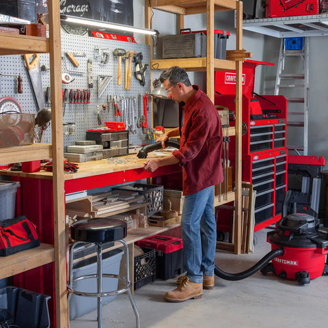 Person using All Purpose Wet Dry Vac Attachment Kit For Home And Shop Use, Industrial Grade Vacuum Accessories For Two And A Half Inch Hoses in garage