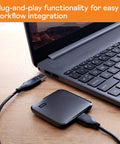 2TB Portable SSD With USB 3 For Quick File Transfers On The Go connected to laptop, showcasing compact design and plug-and-play feature