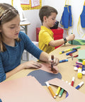 Children using Construction Paper Set 50 Sheets 12 By 18 Inches 10 Assorted Colors for school projects and arts and crafts.