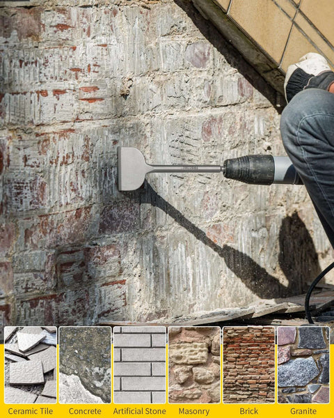 Side view of a gray steel SDS tile removal chisel bit mounted in a hammer drill chiseling a masonry wall.
