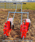 Double Row Hand Push Garden Seeder Roller Seeding And Fertilizer Applicator Manual Seeder Row Planter in field setting