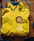 Multifunctional Ruler Compass Outdoor Measuring Scale on yellow jacket, essential for camping and orienteering.